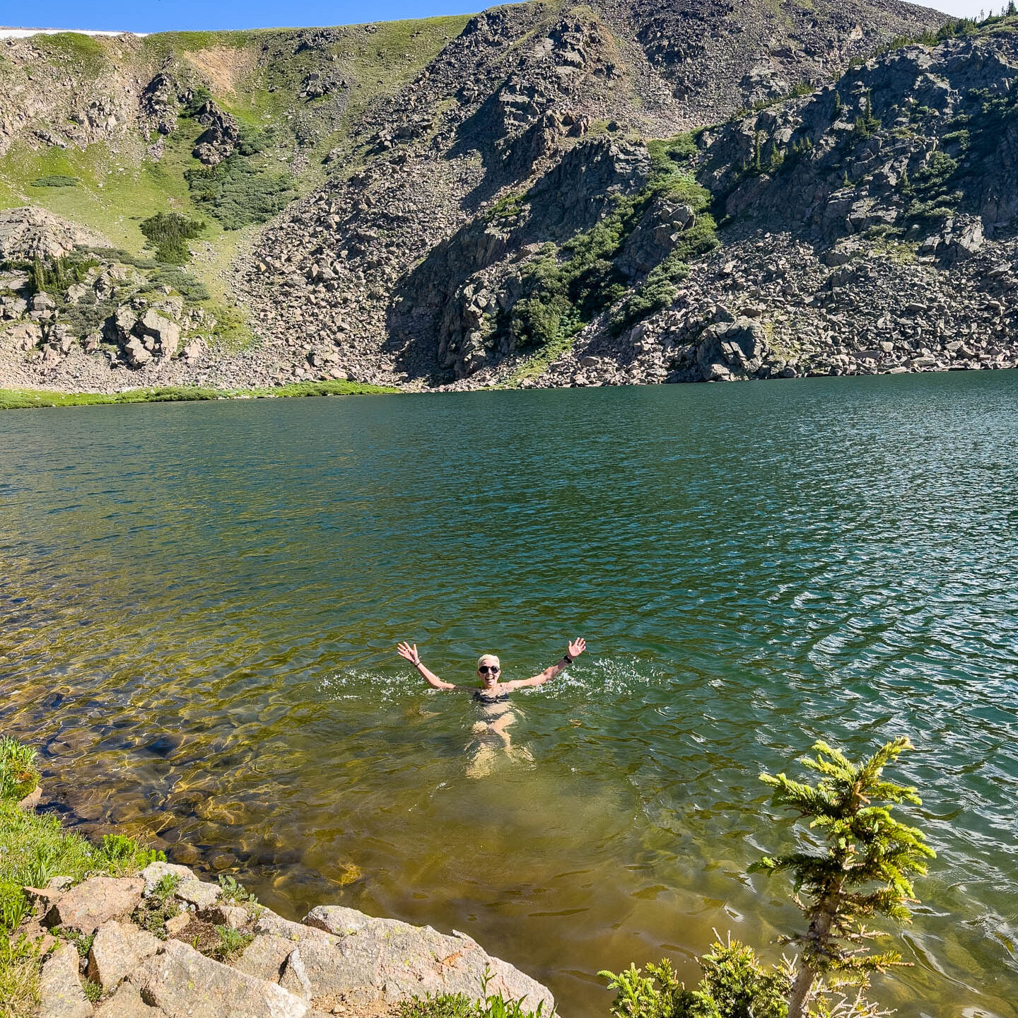 A woman swims in a lake in Colorado.