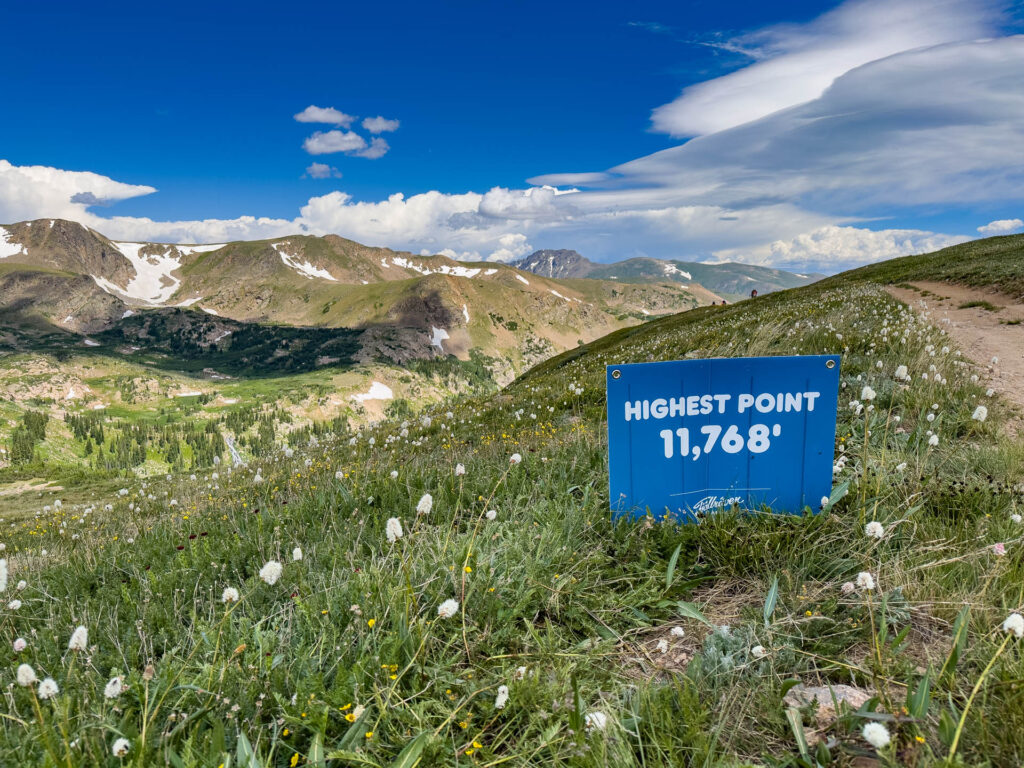 The highest point marked with a sign that says 