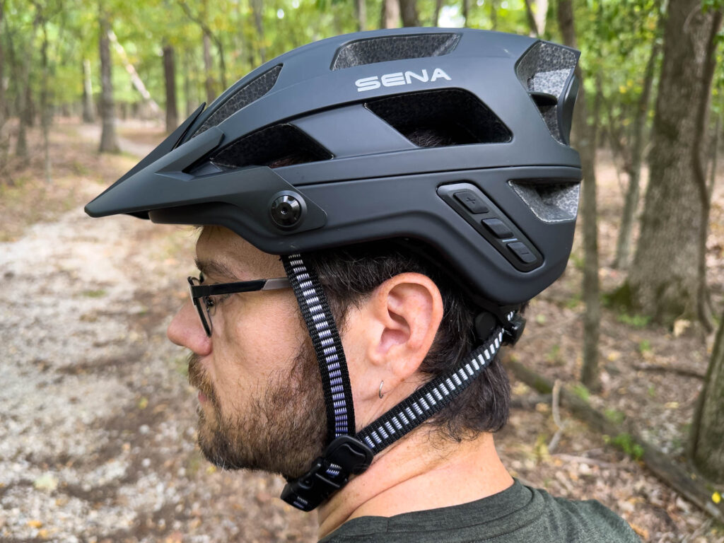 A man wears the Sena M1 Evo Bluetooth intercom helmet.