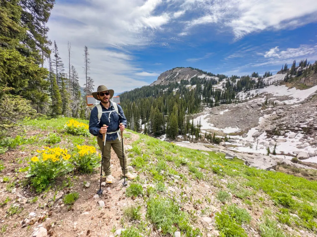 A man smiles next to mountains in Grand Teton National Park.