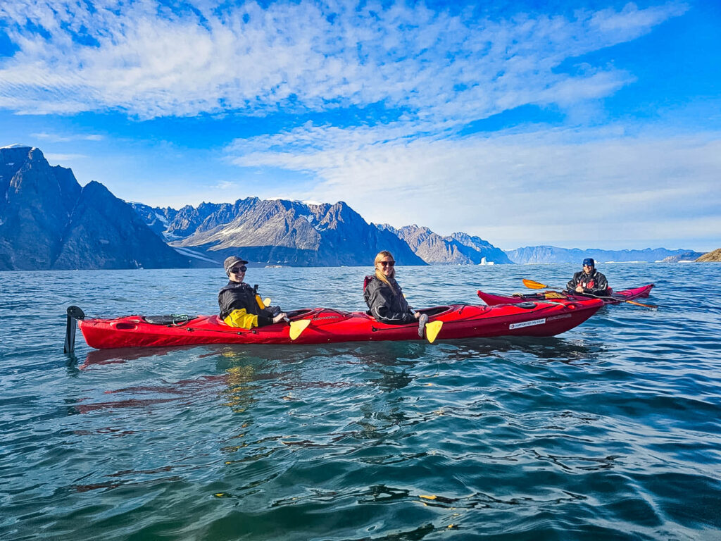 Me (left) and another journalist kayaking in the Fjords of East Greenland.