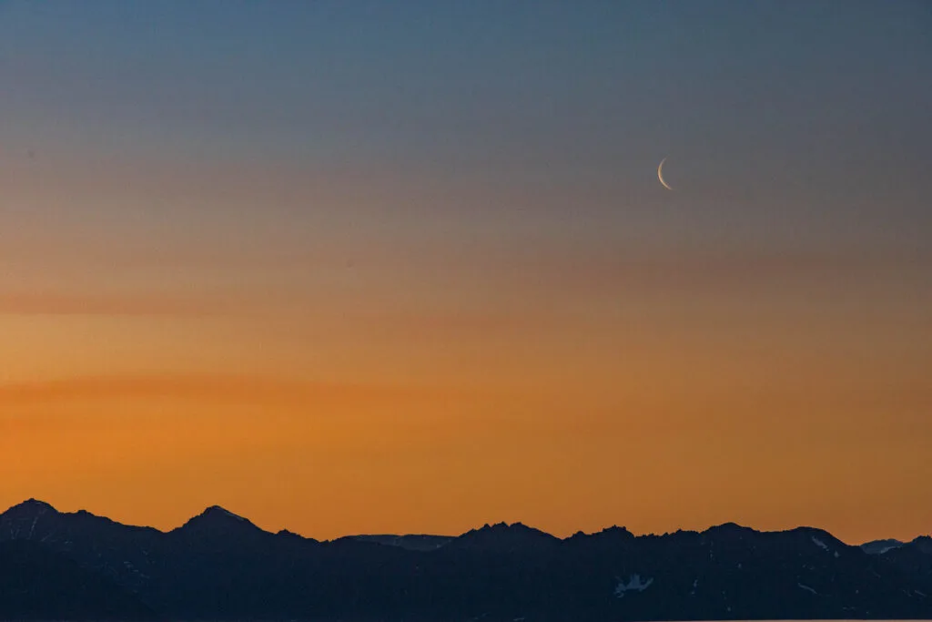 A dusky sunset and moonrise.