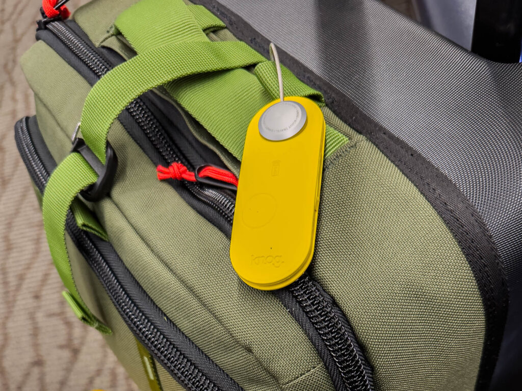 Knog Scout Travel luggage tag and bag finder attached to a suitcase.