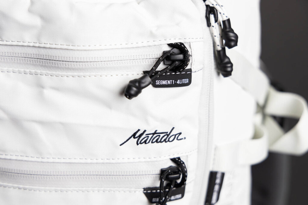 The zipper locks on the front zippers of the Matador SEG28 travel pack.
