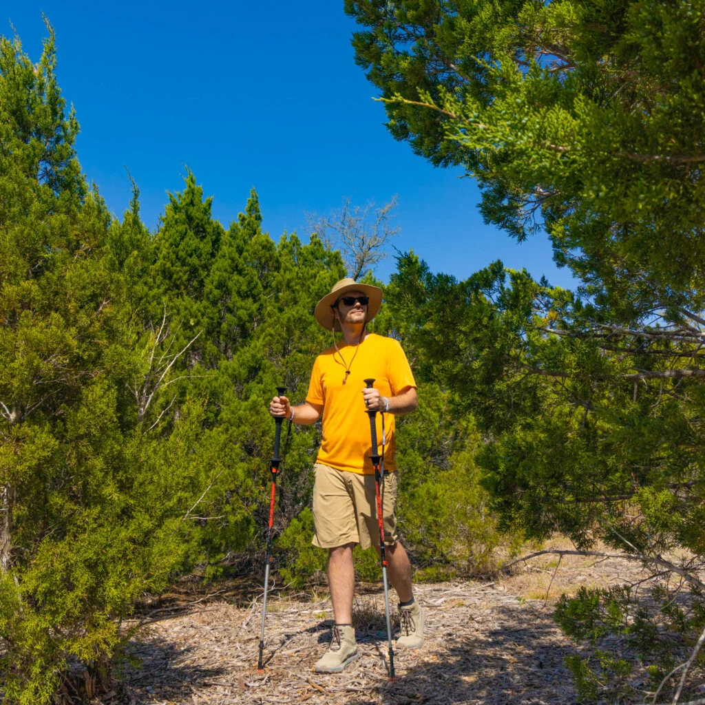 A man Hiking with a pair of TSL trekking poles.
