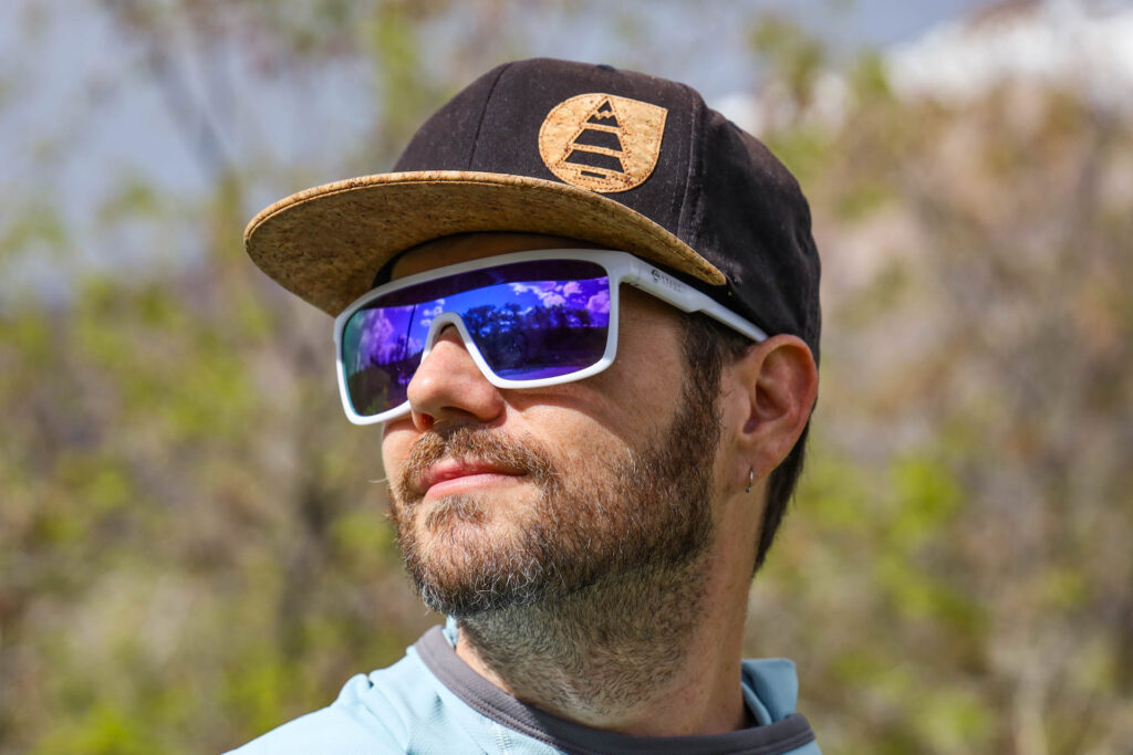 A man wears a pair of Dragon Momentum Sunglasses.