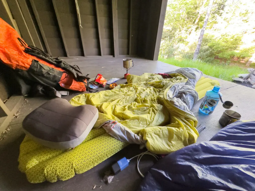 Backpacking gear spread out in a shelter on the Allegheny Trail.