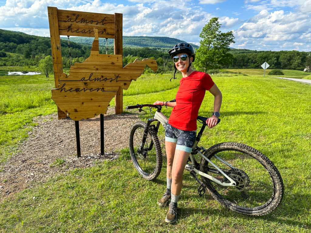 A woman poses with a Mountain bike in Canaan Valley Resort State Park.