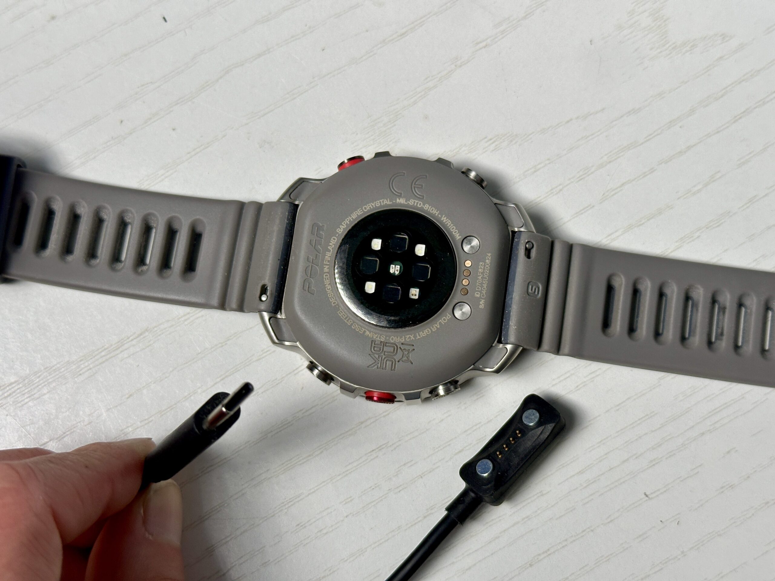 Polar Grit X2 Pro GPS Watch underside and charging cable.