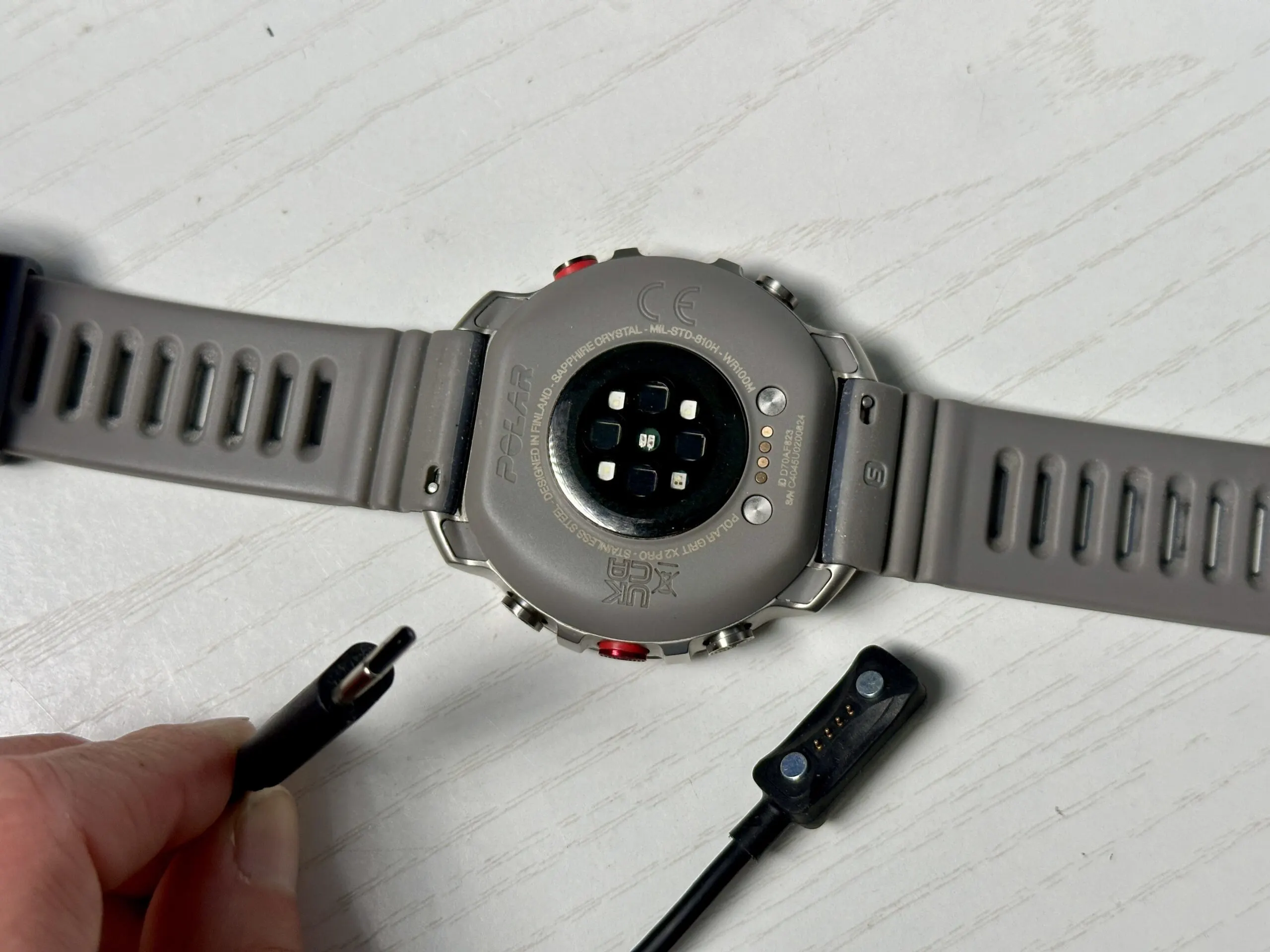 Polar Grit X2 Pro GPS Watch underside and charging cable.