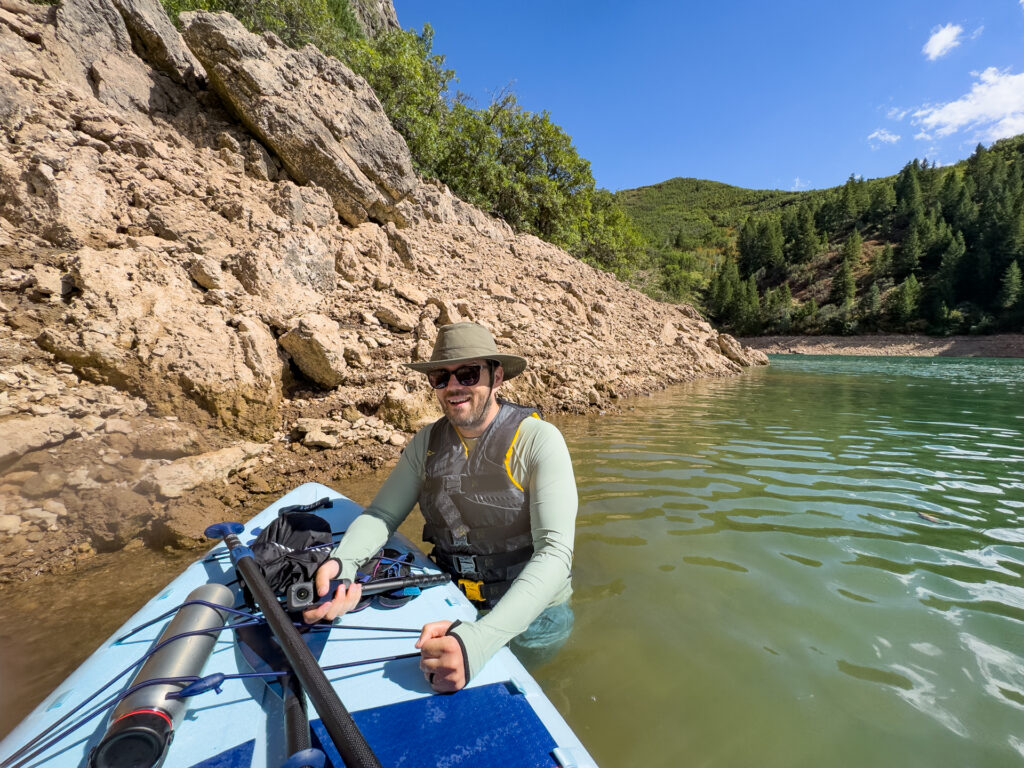 A man in the water next to an Isle Switch Compact SUP.