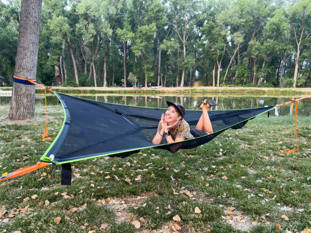 Alisha lounging solo in the Tentsile Trillium Mesh hammock.