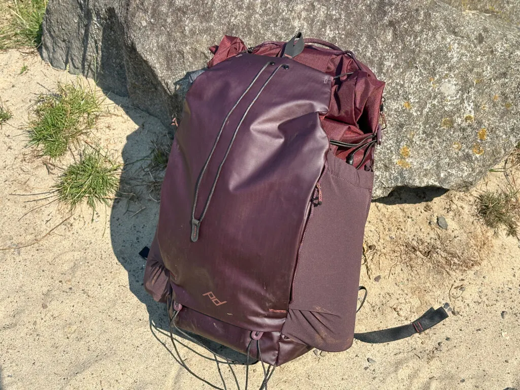 Hiking with the Peak Design Outdoor 25L Backpack in burgundy.