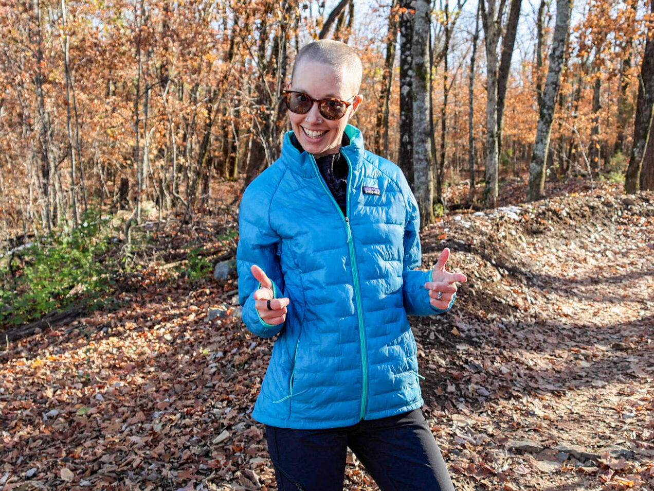 A woman in the Patagonia Micro Puff Insulated Jacket made of recycled fishing nets.