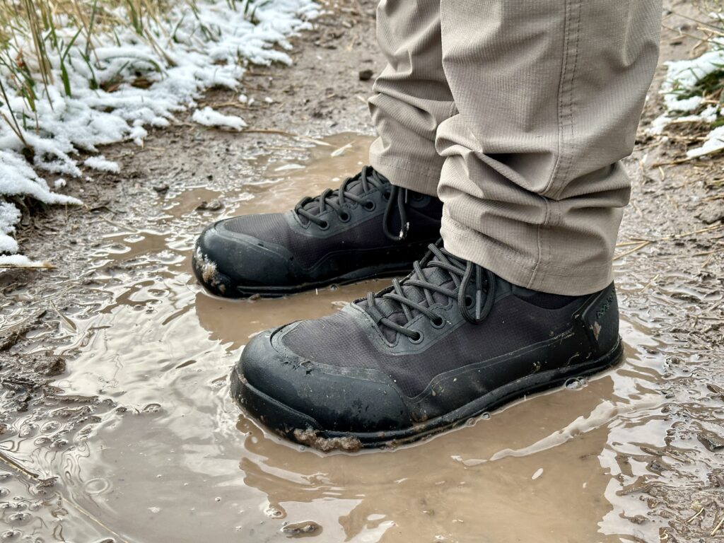 Bahé Rediscover boots standing in a puddle.