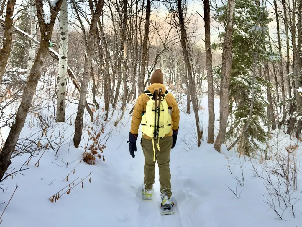 A man snowshoeing down a trail.