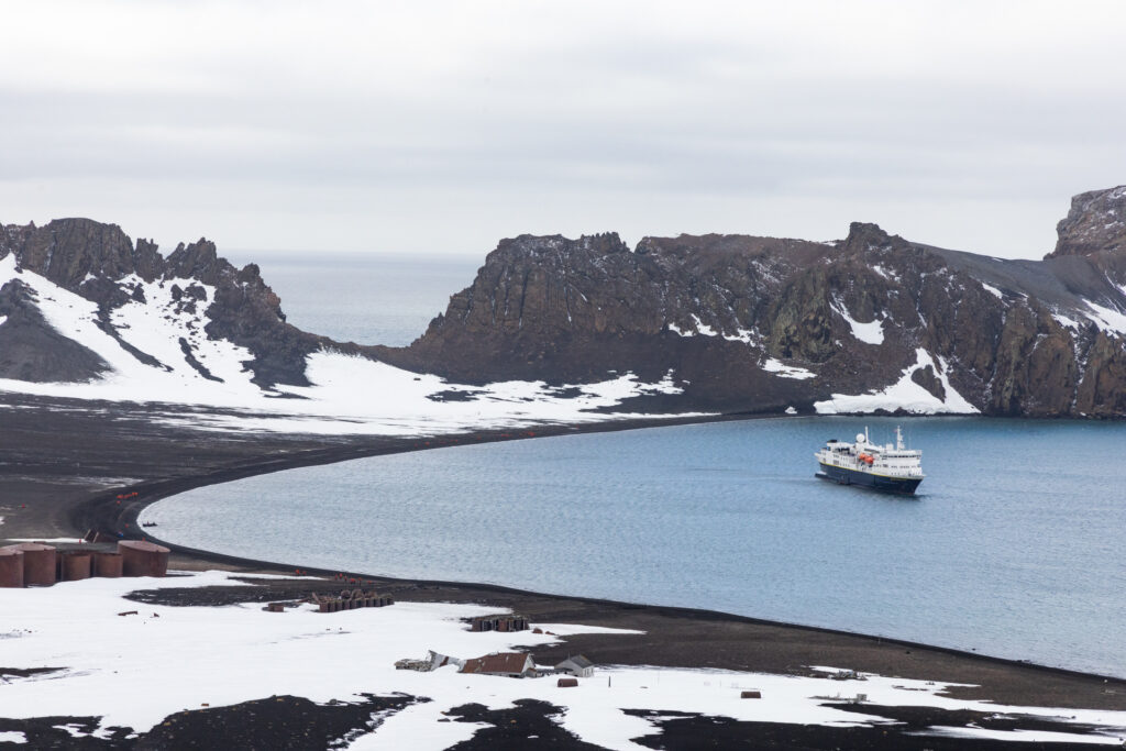 The Lindblad Expeditions National Geographic Explorer in Deception Island bay during an Antarctica Cruise.