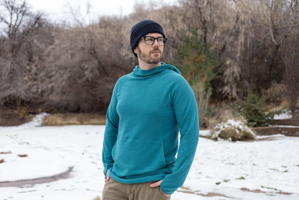 A man wears a Squak grid hoodie.