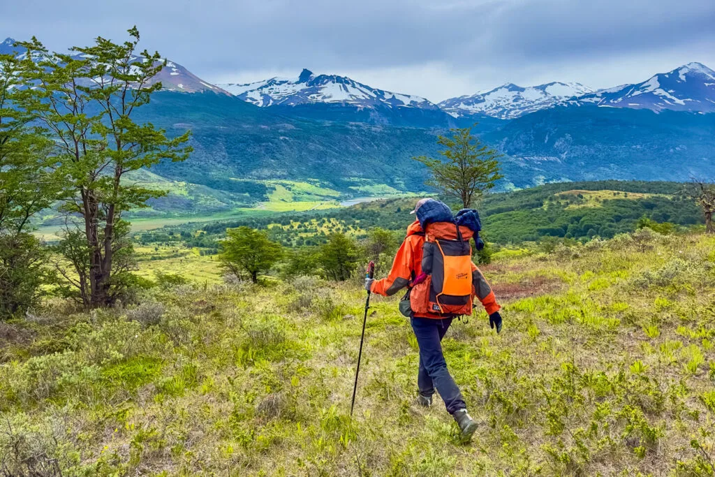 A woman was away with a backpack and trekking pole in Patagonia.