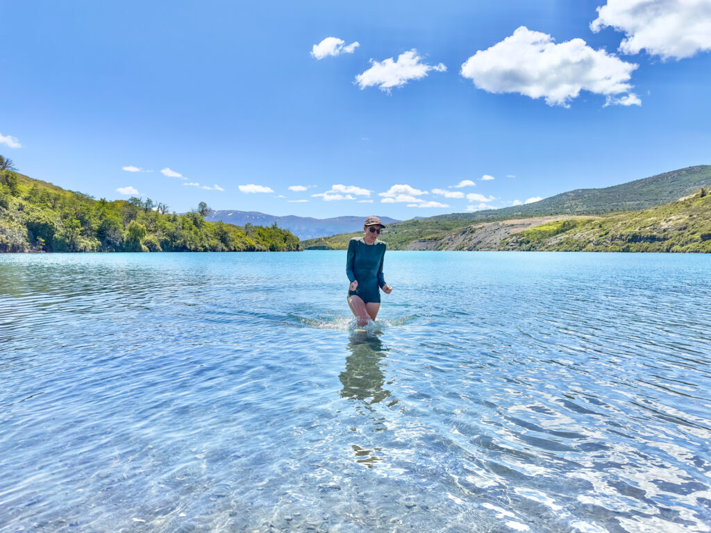 A woman shivers in cold Lago del Toro in Chile.