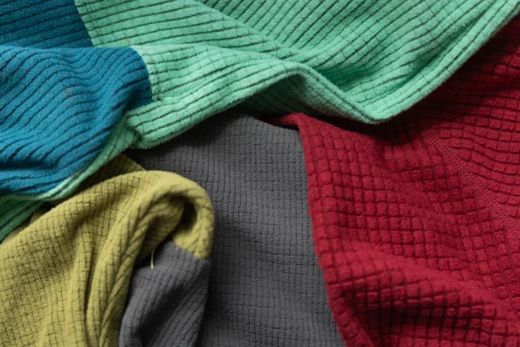 A close up of three different grid fleece fabrics.