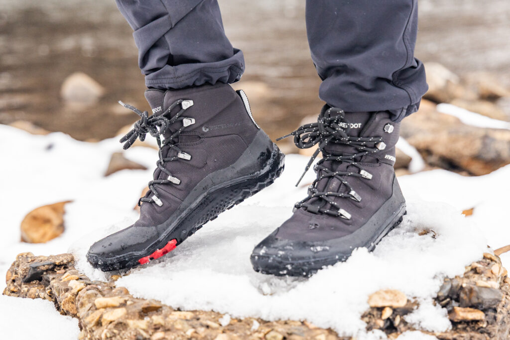 The Vivobarefoot Tracker Textile AT barefoot waterproof hiking boots in the snow.