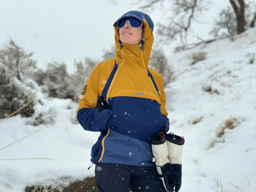 A woman wears a Paramo Jacket in the snow.