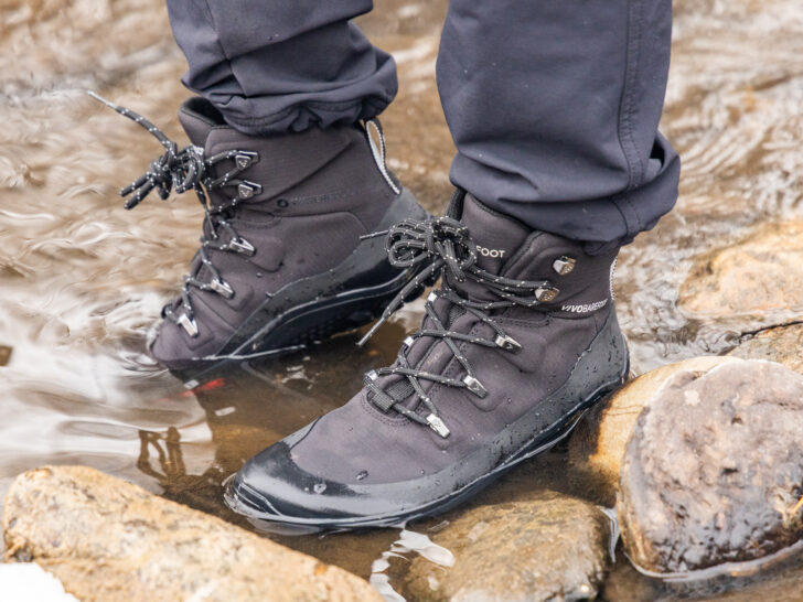 Vivobarefoot hiking boots in a creek.