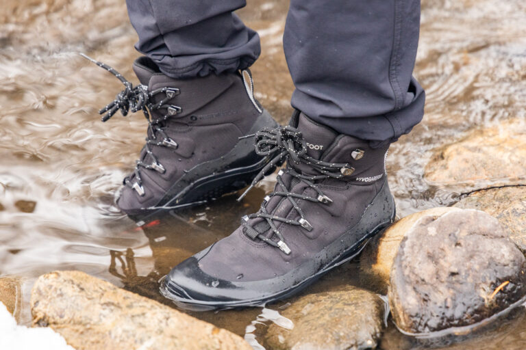 Vivobarefoot hiking boots in a creek.