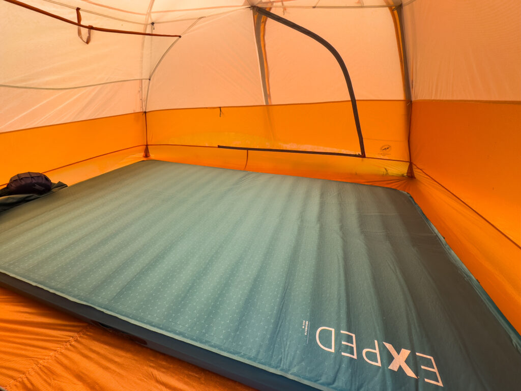 The Exped MegaMat Duo double sleeping pad inflated in a 3-person tent.