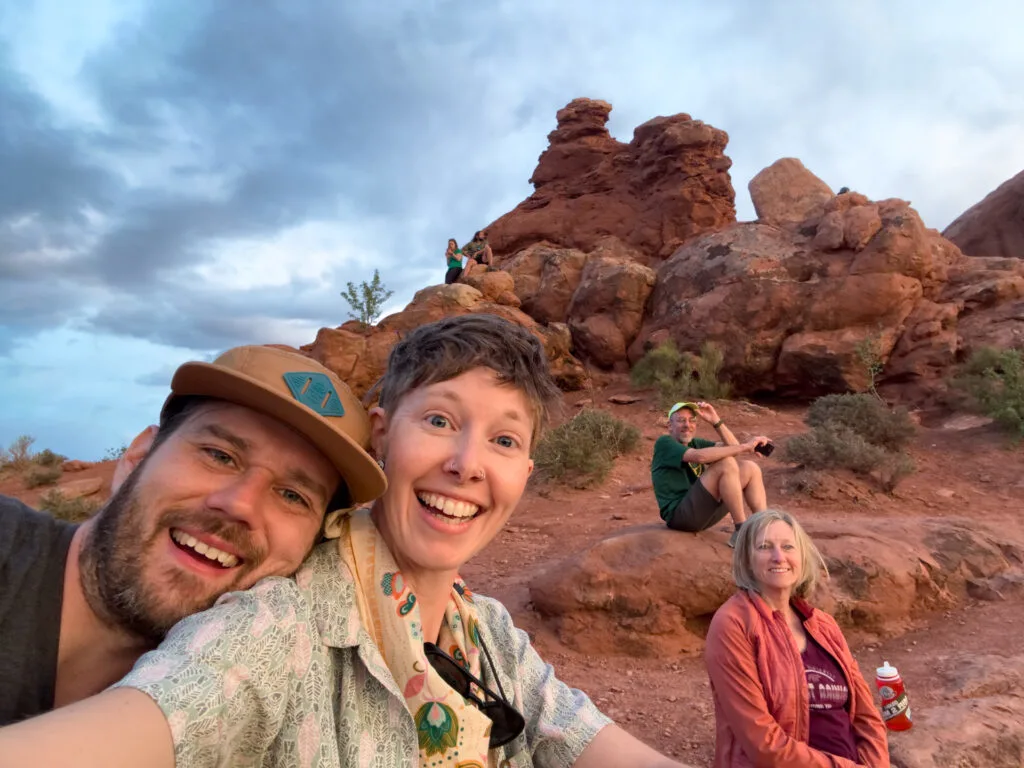 Four people smile at sunset in Zion National Park.