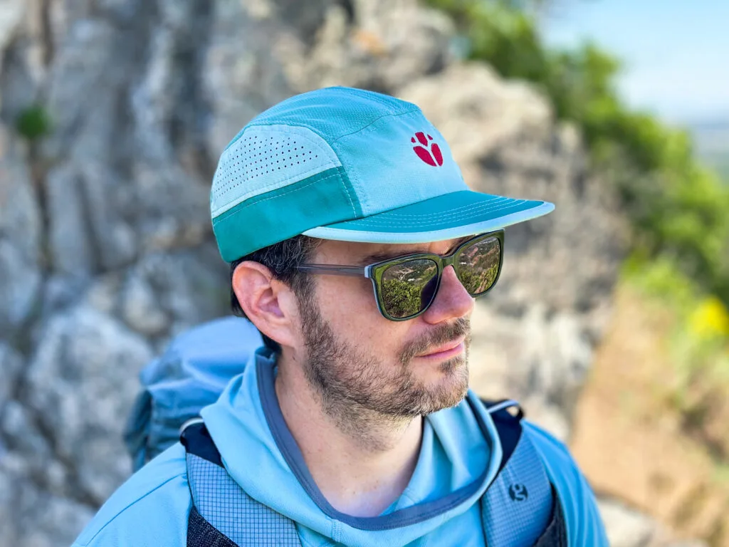 A man wear the Fractal M-Series cap on a hiking trail.