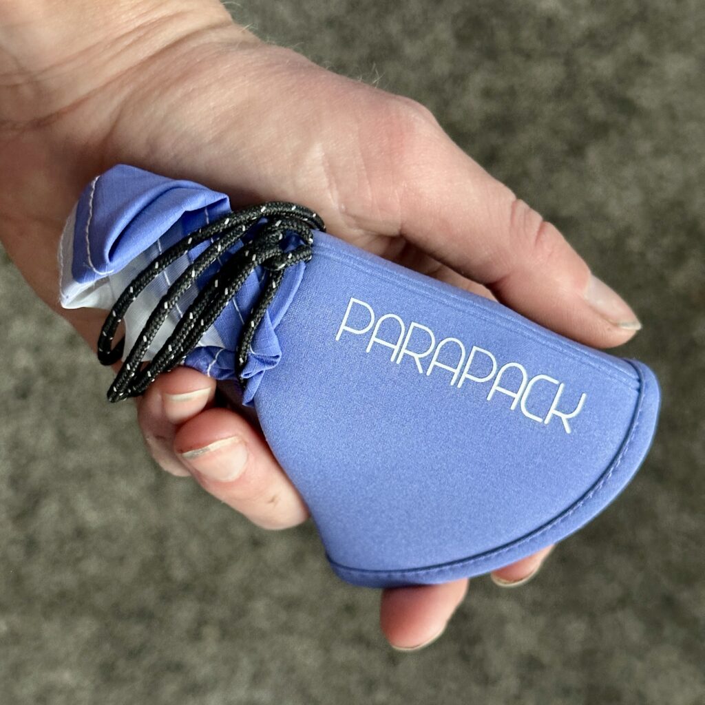 The Parapack Cap folded up into a pocket-sized pouch.