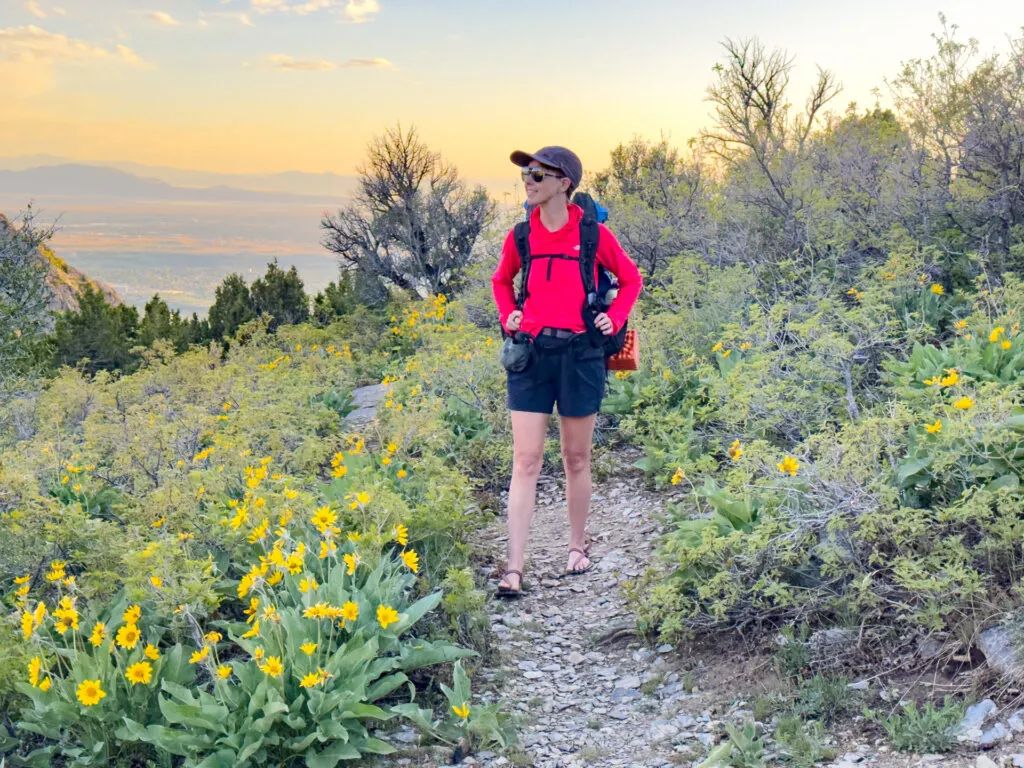 A woman walks on a trail wearing a Zpacks Backpack: the Super Nero Ultra 50.