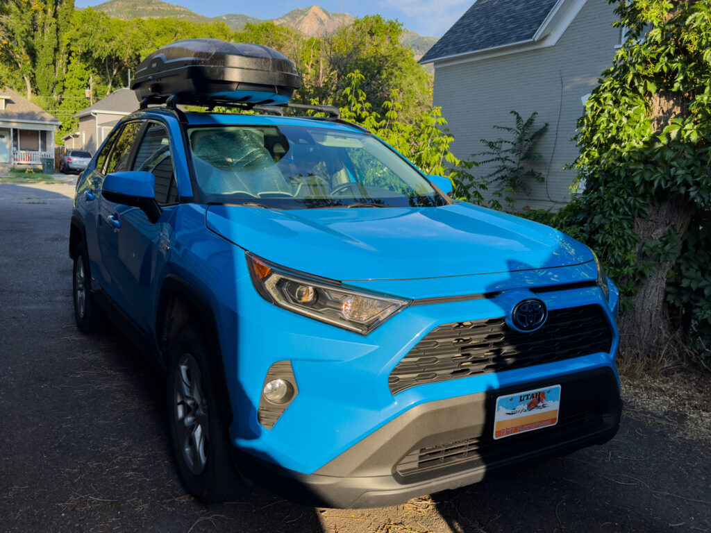 Yakima SkyBox NX Skinny Cargo box closed and mounted in the middle of a Rav4 roof.