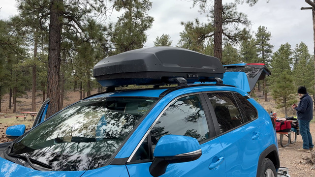 A Thule Force Rooftop cargo box on top of a Rav4.