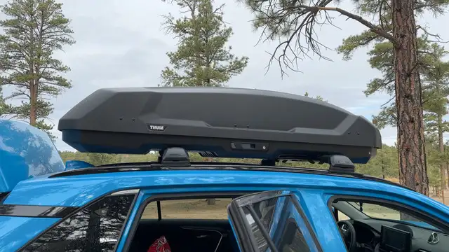 A Thule Force Rooftop cargo box on top of a Rav4.