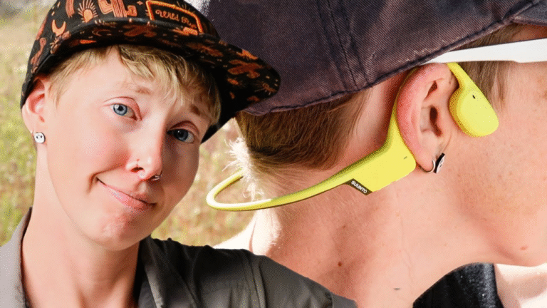 Woman looking smug next to someone wearing Suunto Sonic Bone Conducting headphones