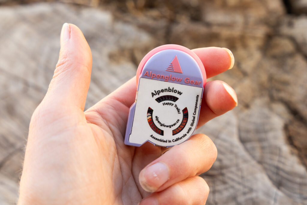 The Alpenglow Gear Alpenblow pump is small and light enough to fit in two fingers.