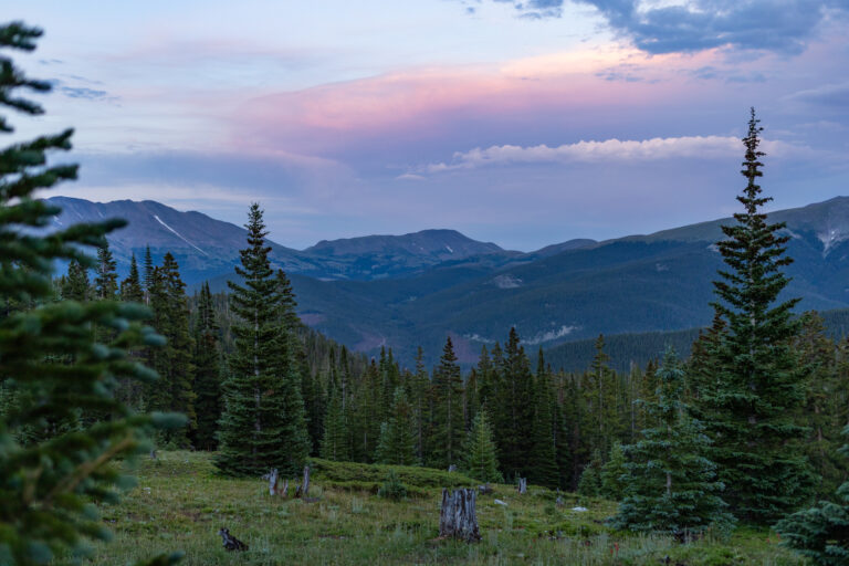 A sunset view of trees and mountains from near Francie's Cabin in Breckenridge, CO.