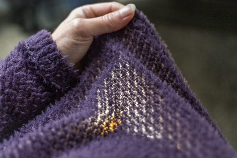 A hand stretch a type of alpha fleece so you can see light coming through.