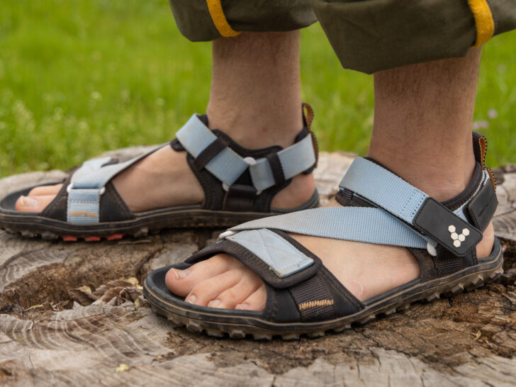 The Vivobarefoot Tracker Ora barefoot hiking sandal on a man's feet.