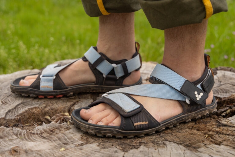 The Vivobarefoot Tracker Ora barefoot hiking sandal on a man's feet.