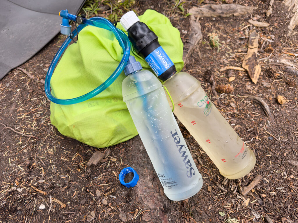Two CNOC reusable bottle and a One Bottle Hydration System hose.