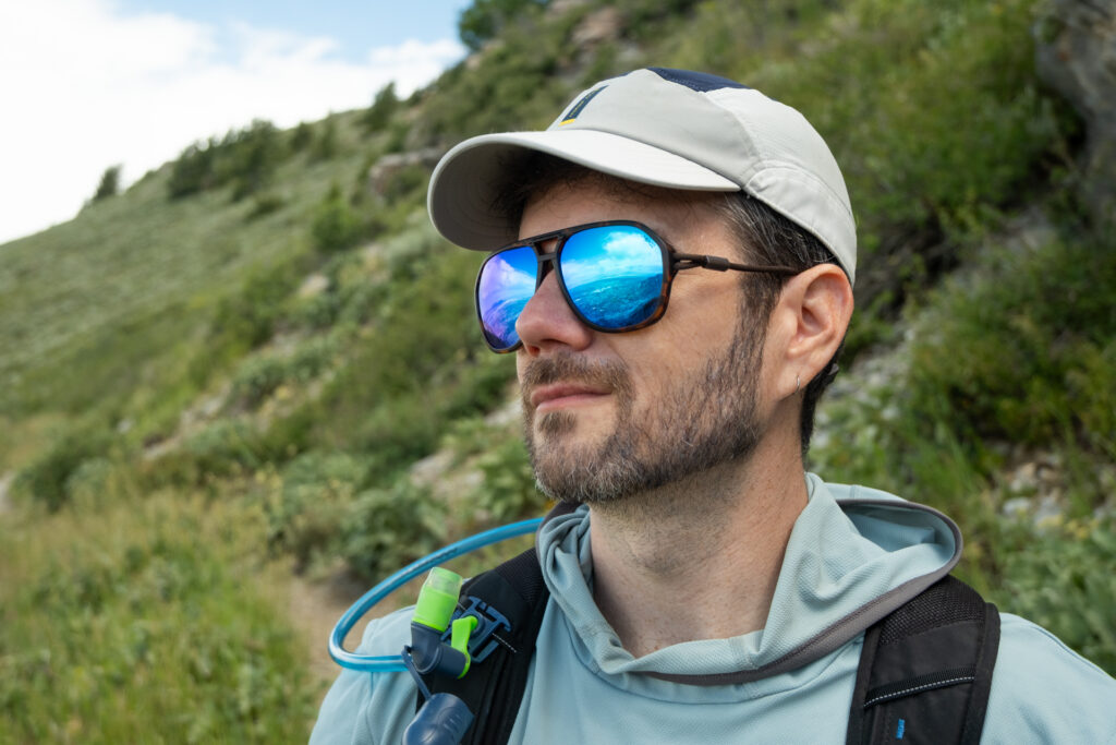 A man on a trail wears Ombrax RX sunglasses.
