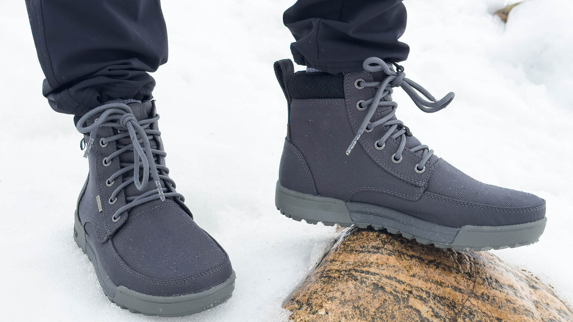 A pair of feet in Lem's Boulder Summit barefoot hiking boots.