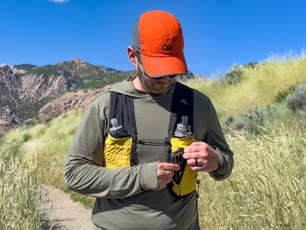 A man wears the La Sportiva Trail Vest 5L on a trail.