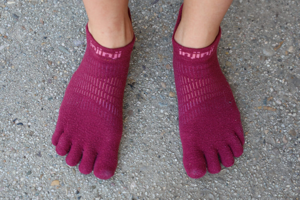 A pair of feet in Injinji Run No Show Socks.