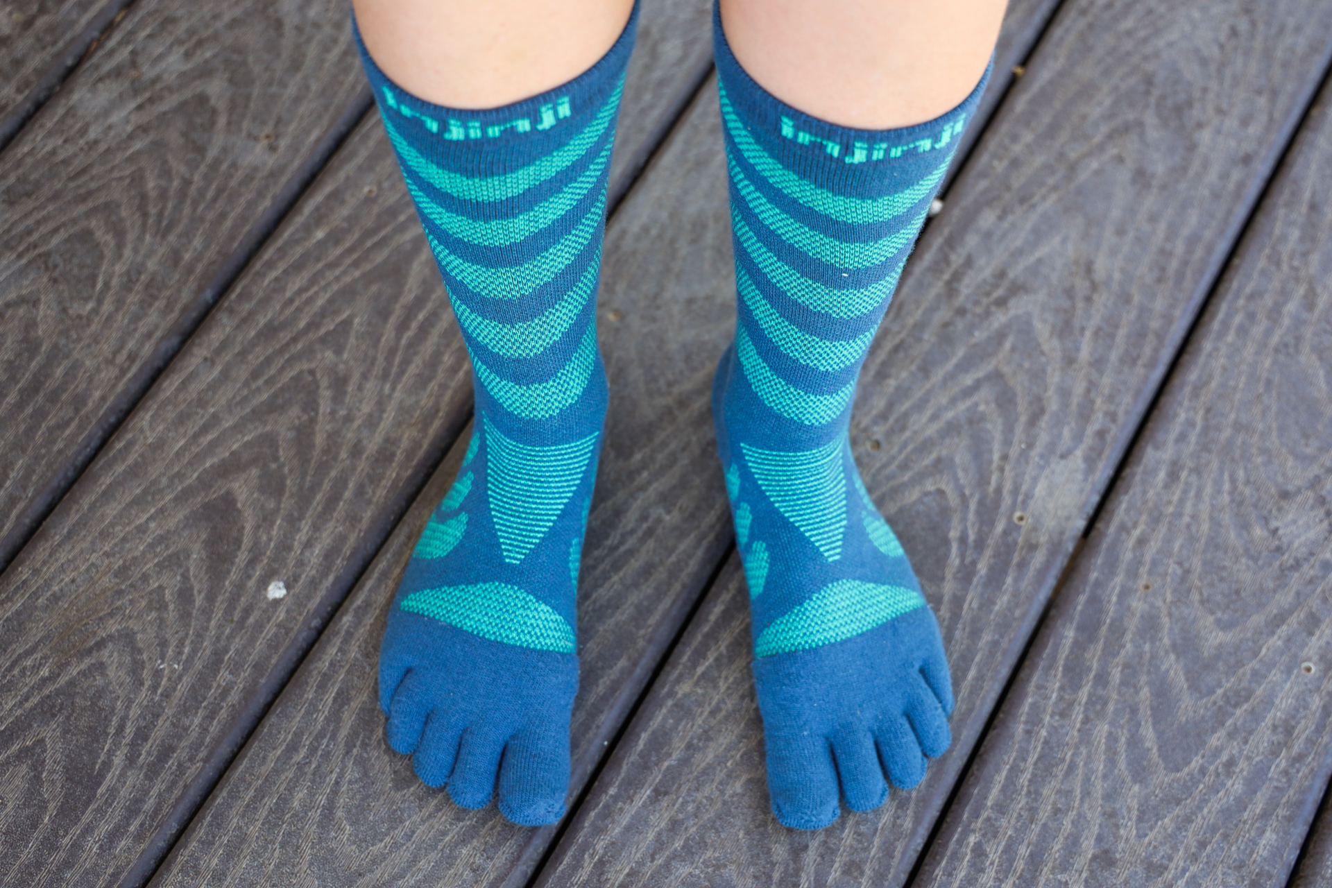 A pair of feet in Injinji Ultra Run crew toe socks.