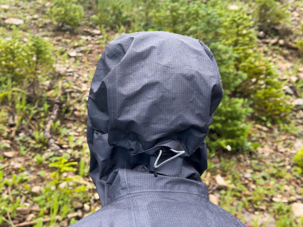 The back of the hood of The La Sportiva Aequilibrium ultralight rain jacket.